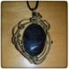 obsidian stone with bronze pendants