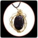 obsidian stone with bronze pendants